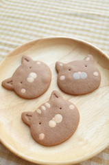 Fototapeta na wymiar Lovely Three Pieces of Homemade Chocolate Cookies Cat Face in Wooden Plate 