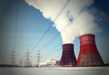 White smoke from the cooling towers against the blue sky.