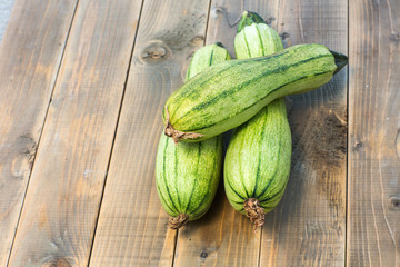green zucchini on a old wooden board