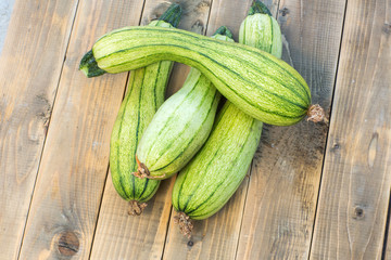 green zucchini on a old wooden board