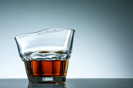 The curved glass of whiskey or alcohol drink