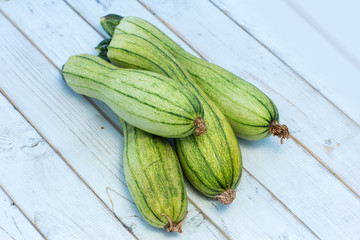 green zucchini on a old wooden board