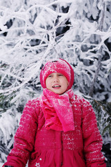 Winter portrait of a adorable 7 years old girl outdoors