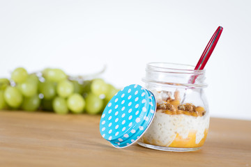 Healthy tapioca pearls pudding dessert with coconut milk and mango served in glass jars 