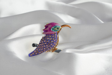 brooch bird with gems on silk