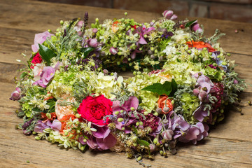 a beautiful flower wreath isolated on awooden background.