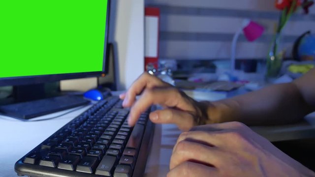 Man hands typing on a computer keyboard green key screen. Close up man indoors hands is typing on keyboard