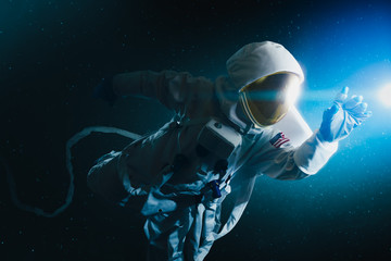 Astronaut floating in outer space , high contrast image - obrazy, fototapety, plakaty