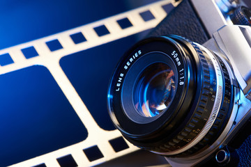 Lens SLR camera on background of perforation film