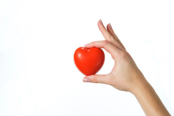 young girl holds a symbolic red heart in the palms. isolated.