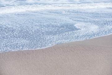 Fototapeta na wymiar Walking on the soft beach sand