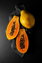 fresh ripe papaya on a napkin and slate plate kitchen table can be used as background