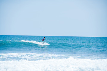 Surfing the waves of Indonesia beach