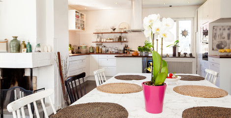 close up of a dining table with  table mats and kitchen unfocused in the background