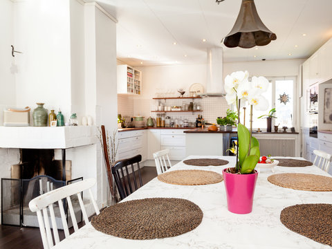kitchen in the background orchid on the table in the foreground