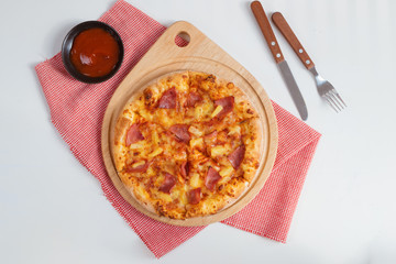 Top view of delicious tasty pizza with ham, tomato, salami, olives and cheese.