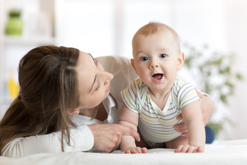 Happy child near to mom in her room