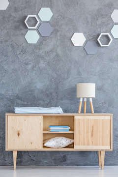 Hexagon decoration above wooden cupboard