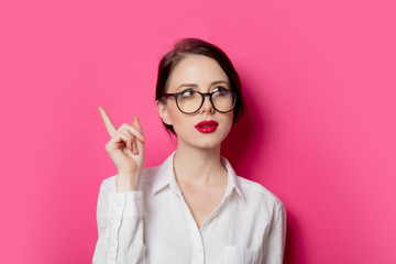 Portrait of young surprised businesswoman in eyeglasses