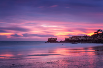 Fototapeta na wymiar Red magic sunset on the beach of Oura in Albufeira. Portugal