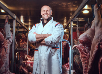 The butcher in a meat freezer storage.