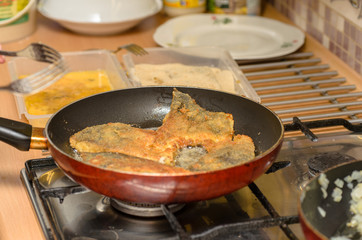 Frying the fish - carp, at home in the oil pan.