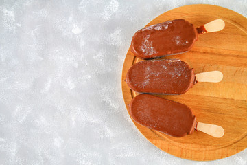 Ice cream eskimo pie on a stick with a copy space for text on a gray background. Concept for the holiday International Eskimo pie day.