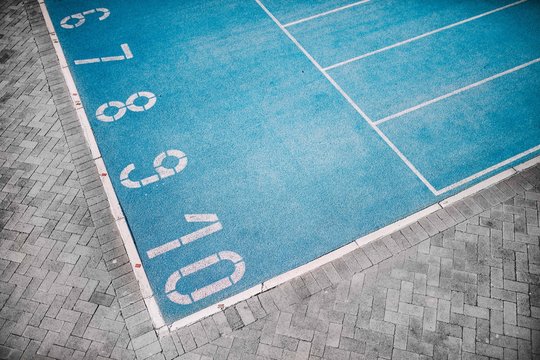 Photo of blue running track with numbers