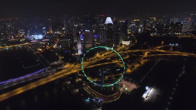 Gorgeous 4k aerial drone view on big city Singapore by ocean metropolis downtown in bright night light illumination
