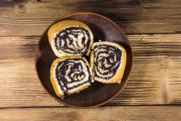 Poppy seed rolls on wooden table