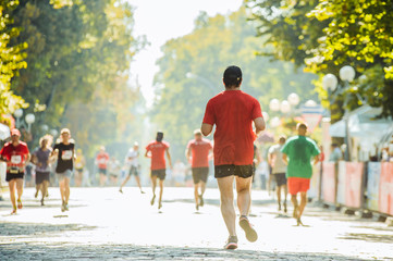 Fototapeta premium Athletes run in the park on the running marathon
