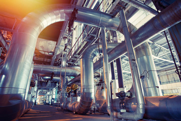 Equipment, cables and piping as found inside of a modern industrial power plant