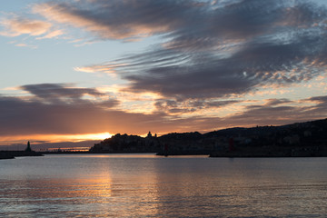 Stormy clouds of contrasting color over the evening city