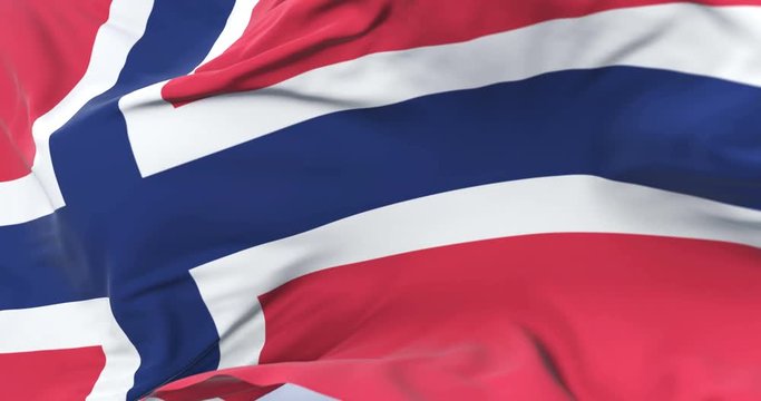 Flag of Norway waving at wind with blue sky in slow, loop
