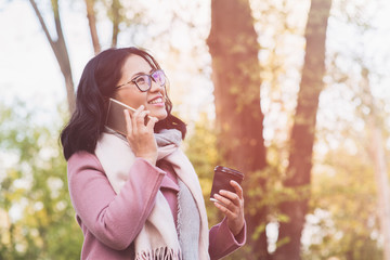 Girl is talking on the phone outdoor.