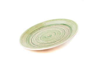 Green round ceramic plate with spiral pattern, isolated on white