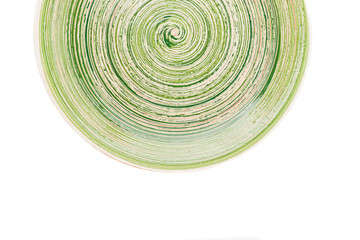 Green round ceramic plate with spiral pattern, isolated on white