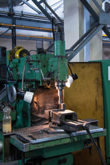 The CNC milling machine cutting the sample part with the flat endmill in light blue scene.The rough endmill cutter for CNC machine with lighting effect