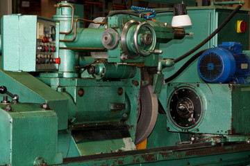 metalworking machining industry. finishing or grinding metal surface on grinder machine at factory