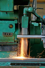 metalworking machining industry. finishing or grinding metal surface on grinder machine at factory
