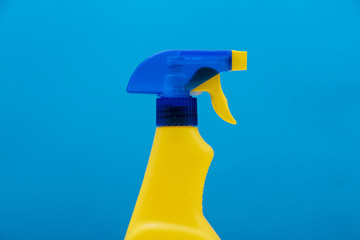 Cleaning spray bottle products on a bright blue background