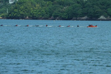 Line of surf boards being towed in the Menai Straits
