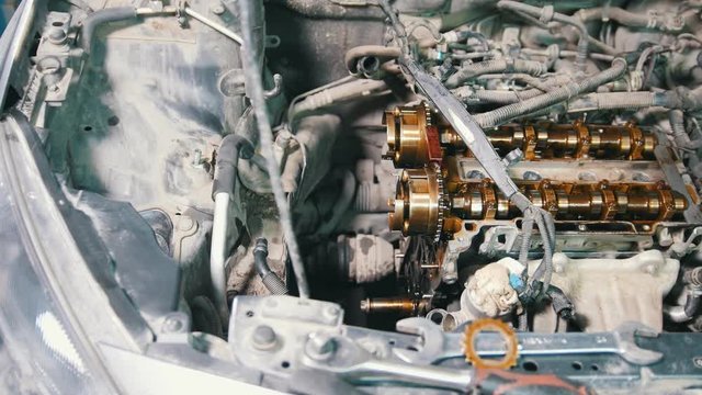 Mechanic dismantles the engine of a car, car repair, disassembly of the engine, working in the workshop