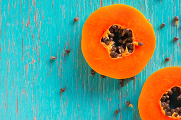 Papaya fruit on wooden background.Slices of sweet papaya on wooden background,Halved papayas
