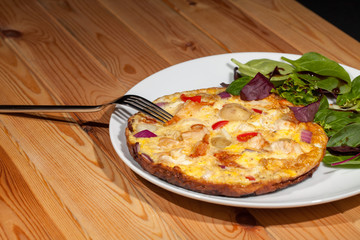 Healthy nutritional slimmer meal. Spanish omelette and baby leaf salad
