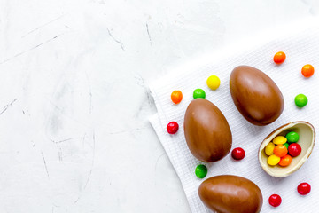 Easter chocolate eggs top view on stone background mock up