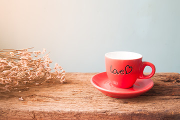 Red cup of coffee with LOVE on wooden table, Love and Valentine's Day concept