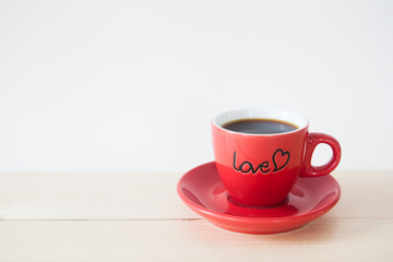 Hot coffee in LOVE red cup, Valentine's Day concept with copy space