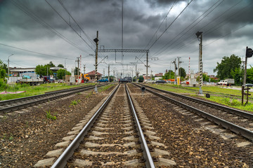 Fototapeta premium Cars cross the railroad tracks on the asphalted railroad crossing