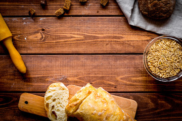 Baking homemade bread on wooden background top view moke up